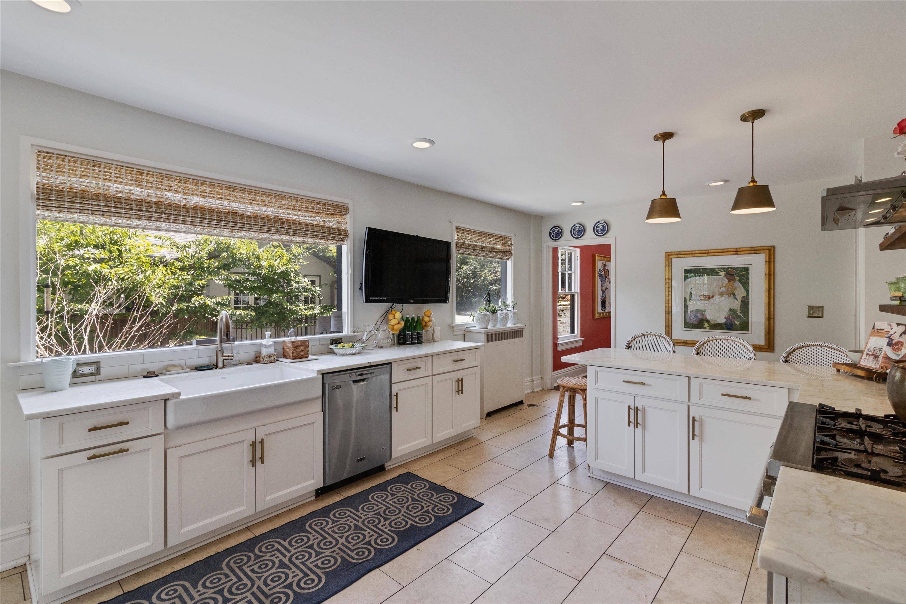 2346 North Strathmore Circle Memphis, TN 38112 - Photo 33 of 40 a large white kitchen with stainless steel appliances granite countertop a sink and cabinets
