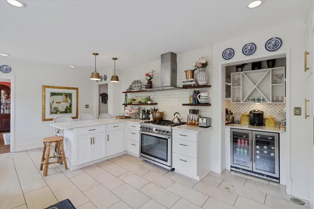 a kitchen with stainless steel appliances granite countertop a stove and cabinets