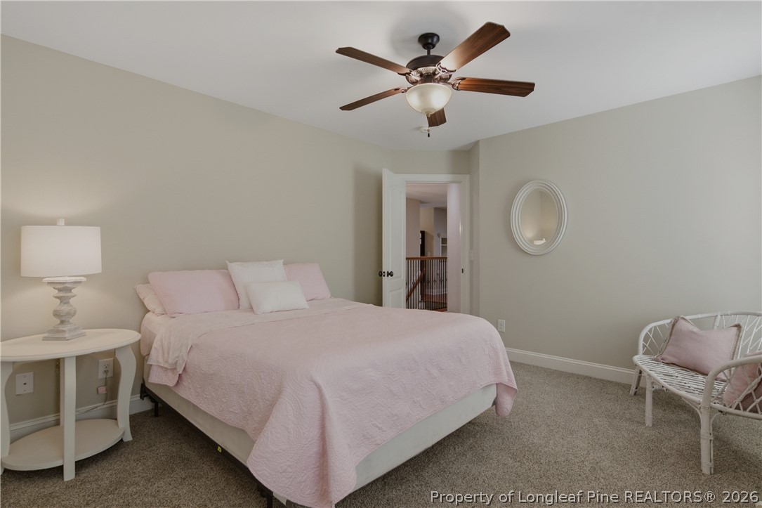 14 Spring Water Court Spring Lake, NC 28390 - Photo 19 of 34 a bedroom with a bed chandelier and a window