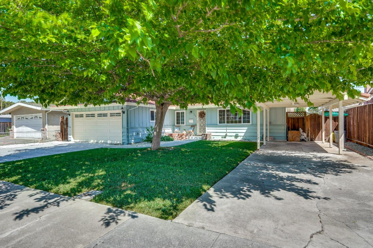 1755 Ravizza Avenue Santa Clara, CA 95051 - Photo 4 of 36 a front view of a house with a yard and a garage