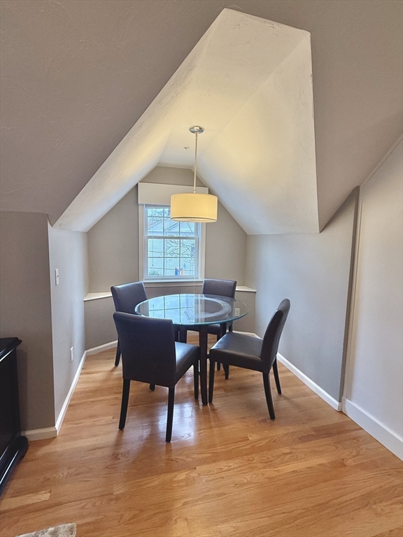 56 Eliot Street, Unit C Natick, MA 01760 - Photo 11 of 21 a view of a dining room with furniture window and wooden floor