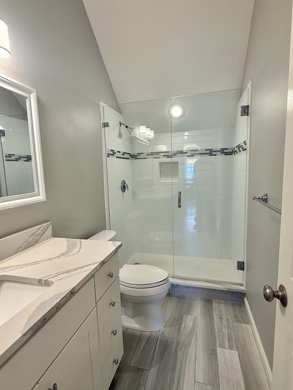 56 Eliot Street, Unit C Natick, MA 01760 - Photo 15 of 21 a bathroom with a sink a toilet a mirror and shower