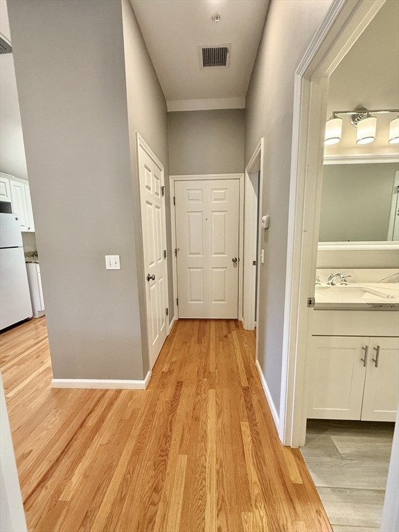 56 Eliot Street, Unit C Natick, MA 01760 - Photo 17 of 21 a view of a bathroom from a hallway