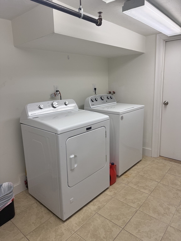 56 Eliot Street, Unit C Natick, MA 01760 - Photo 21 of 21 a utility room with dryer and washer