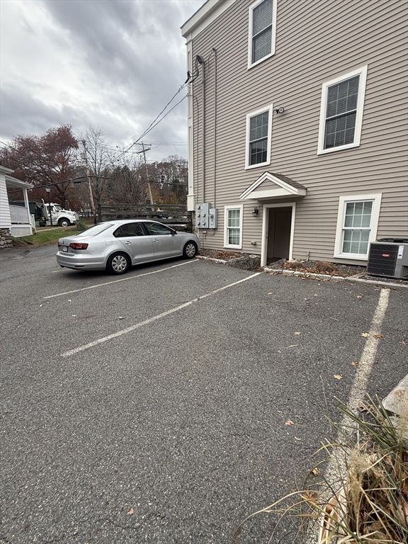 56 Eliot Street, Unit C Natick, MA 01760 - Photo 3 of 21 a view of street with parked cars
