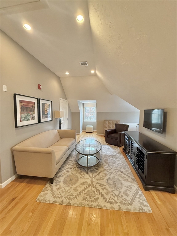 56 Eliot Street, Unit C Natick, MA 01760 - Photo 7 of 21 a living room with furniture and a flat screen tv