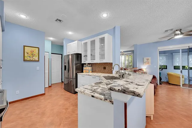 a kitchen with stainless steel appliances granite countertop a refrigerator and a stove
