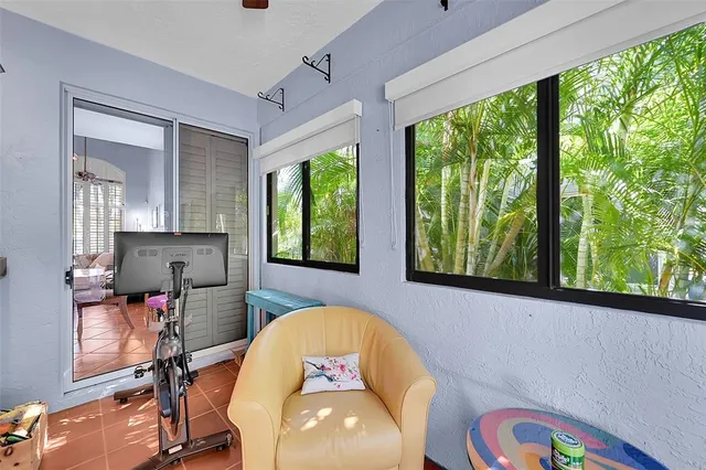 a view of a bedroom with furniture and a window