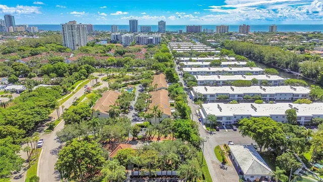 an aerial view of residential houses with outdoor space and street view