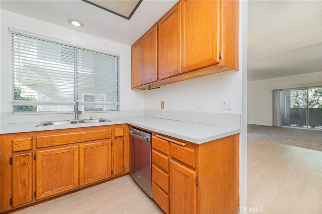 527 Springbrook North Irvine, CA 92614 - Photo 11 of 24 a kitchen with stainless steel appliances granite countertop a sink and cabinets