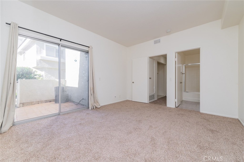 527 Springbrook North Irvine, CA 92614 - Photo 18 of 24 an empty room with sliding glass door and shower