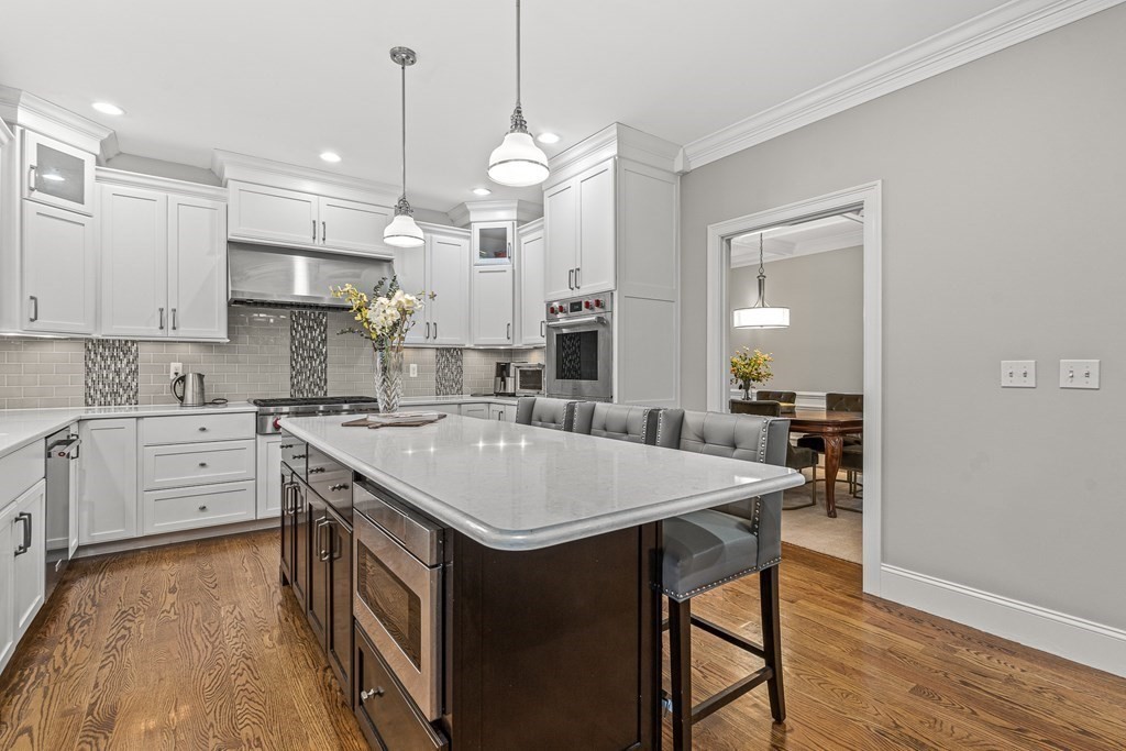 7 Pinevale Avenue Wellesley, MA 02482 - Photo 11 of 34 a large kitchen with kitchen island a stove a sink a center island and cabinets