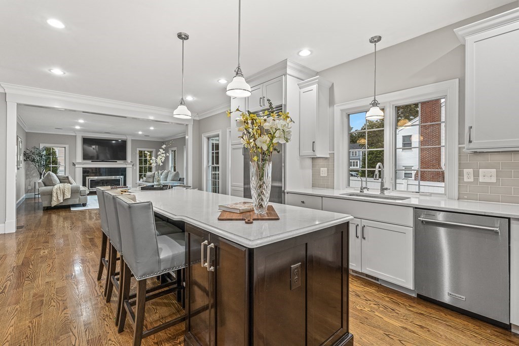 7 Pinevale Avenue Wellesley, MA 02482 - Photo 12 of 34 a dining table with chairs and kitchen view