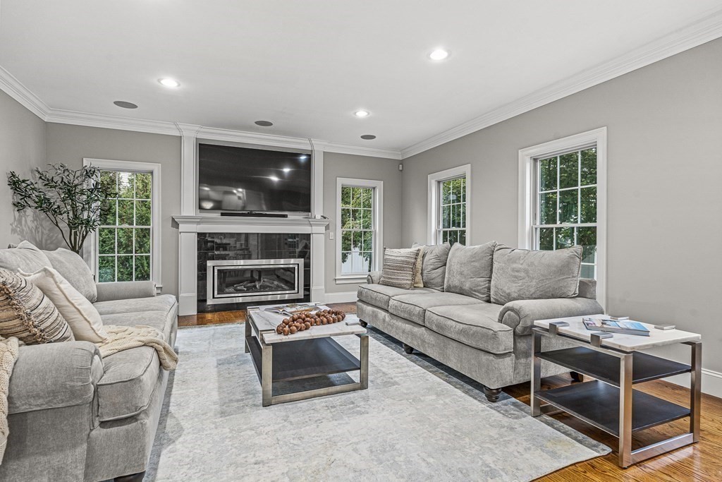 7 Pinevale Avenue Wellesley, MA 02482 - Photo 17 of 34 a living room with furniture a flat screen tv and a fireplace