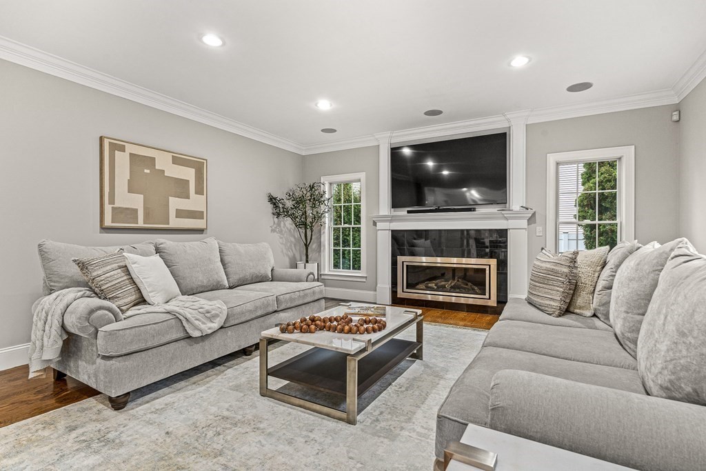 7 Pinevale Avenue Wellesley, MA 02482 - Photo 18 of 34 a living room with furniture a flat screen tv and a fireplace
