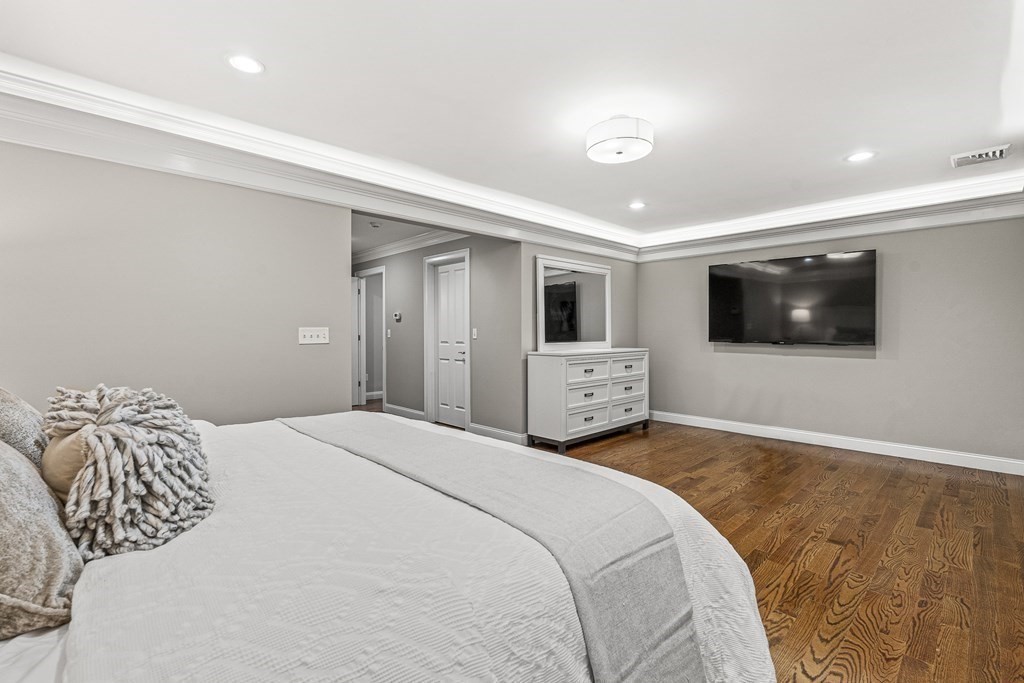 7 Pinevale Avenue Wellesley, MA 02482 - Photo 25 of 34 a bedroom with a bed and a flat screen tv