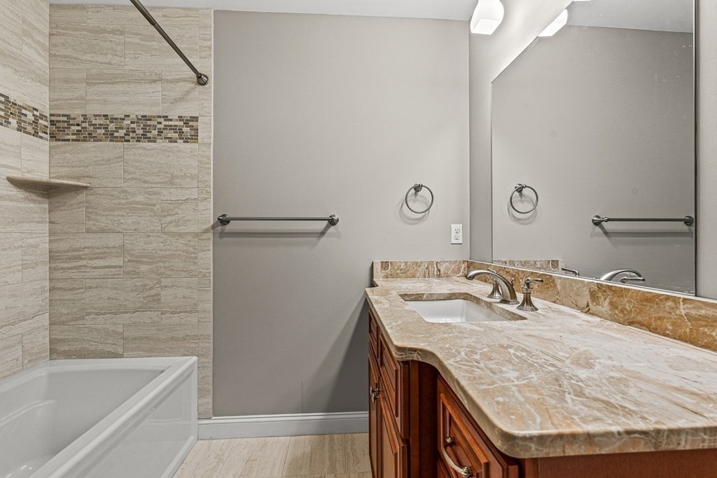 7 Pinevale Avenue Wellesley, MA 02482 - Photo 29 of 34 a bathroom with a granite countertop sink a mirror and shower