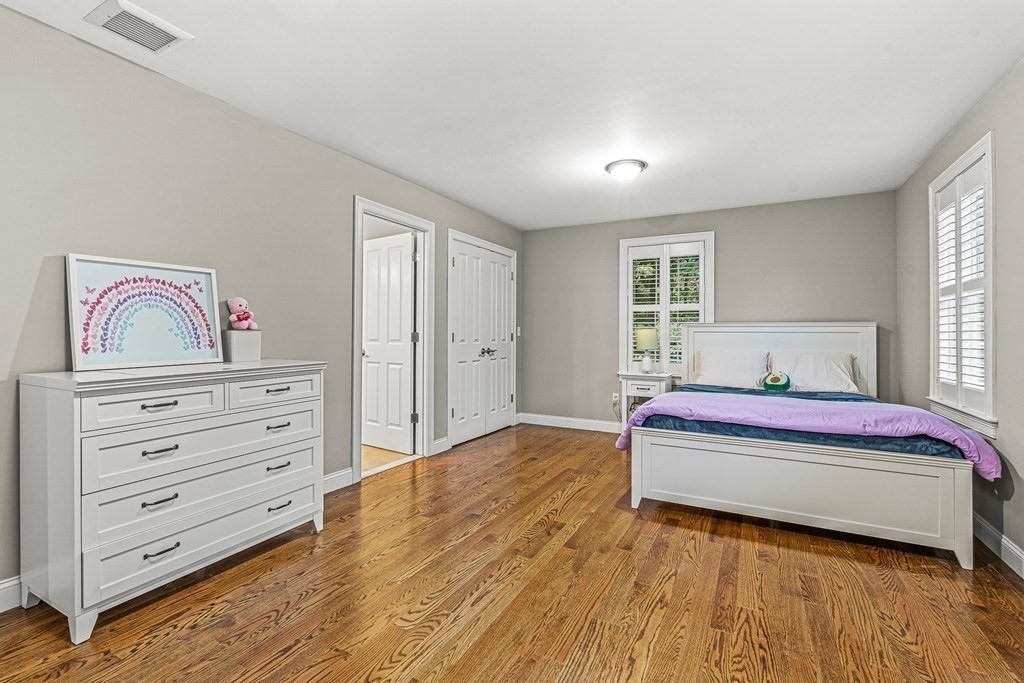 7 Pinevale Avenue Wellesley, MA 02482 - Photo 30 of 34 a bedroom with a bed and wooden floor