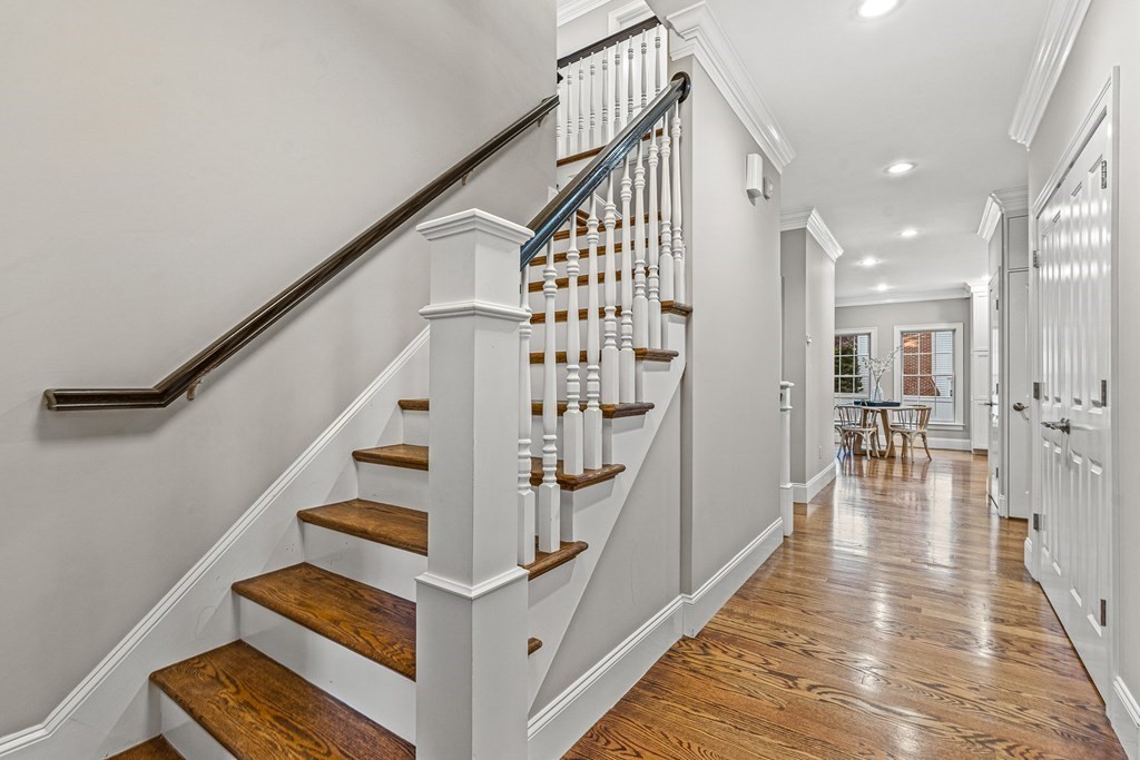 7 Pinevale Avenue Wellesley, MA 02482 - Photo 3 of 34 a view of staircase with lots of frames on wall and wooden floor