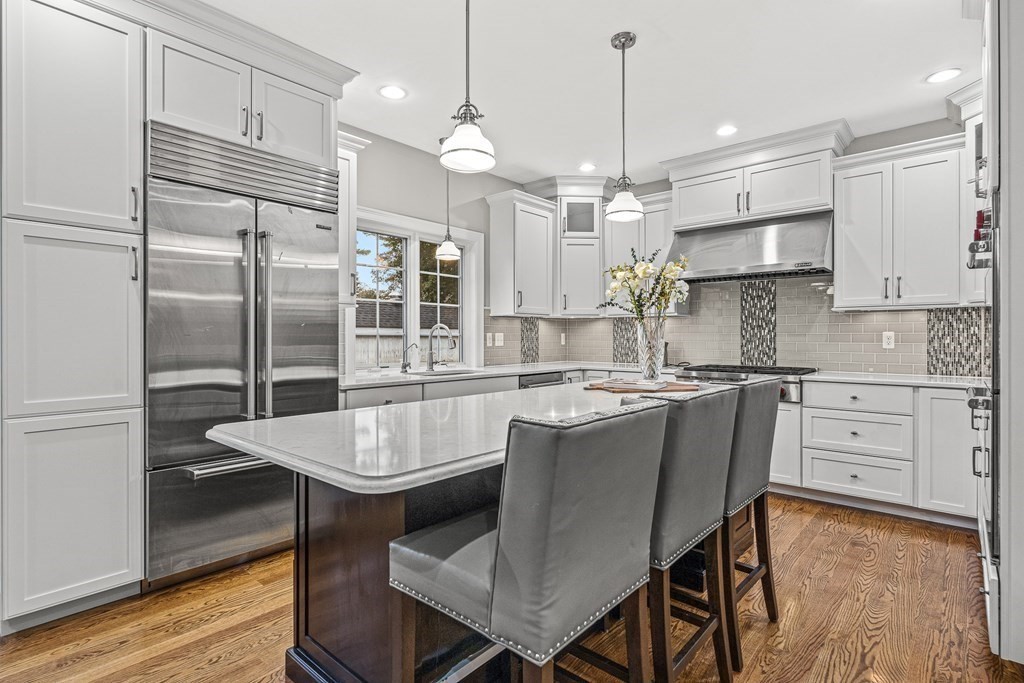 7 Pinevale Avenue Wellesley, MA 02482 - Photo 10 of 34 a kitchen with kitchen island granite countertop a sink a center island stainless steel appliances and cabinets