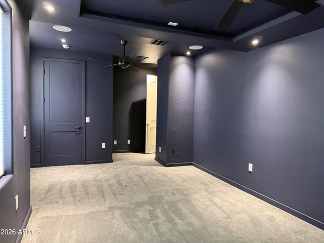 a view of a livingroom with a ceiling fan and window