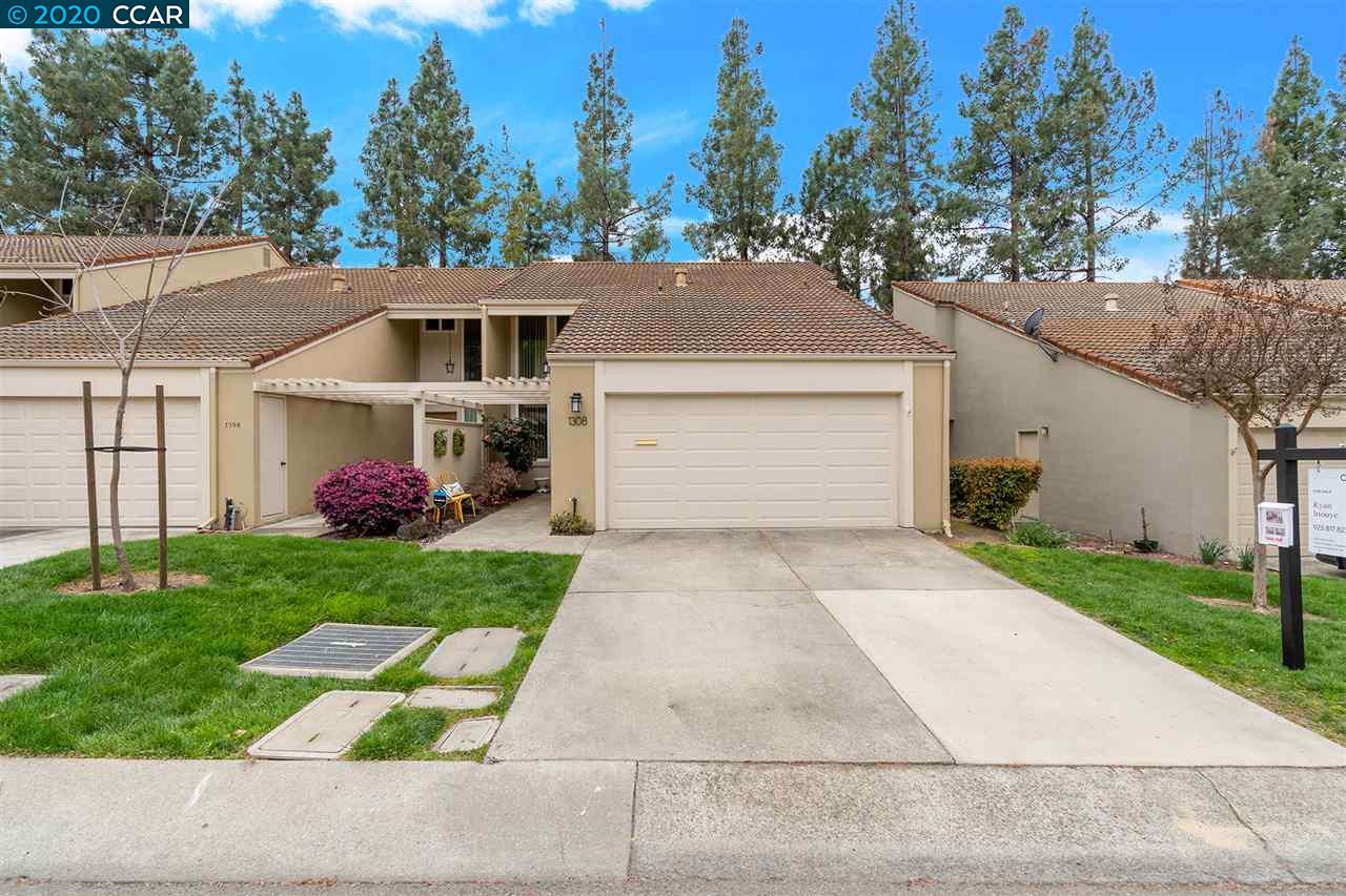 a front view of a house with a yard and a garage