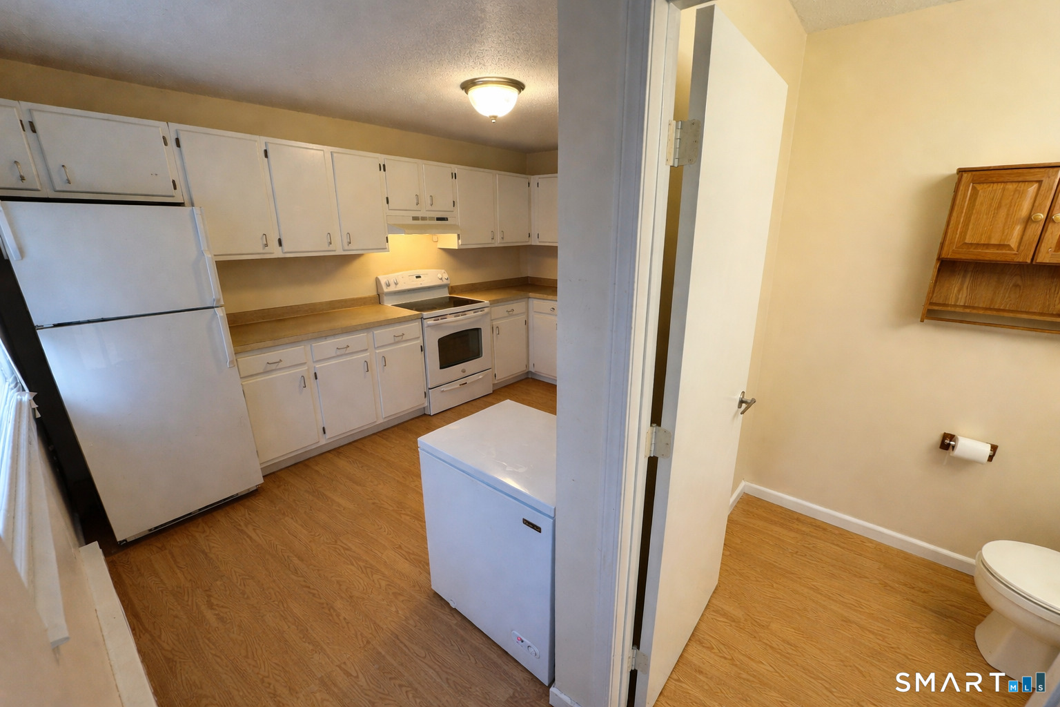 519 Scott Road, Unit 60 Waterbury, CT 06705 - Photo 1 of 1 a kitchen with white cabinets and white appliances