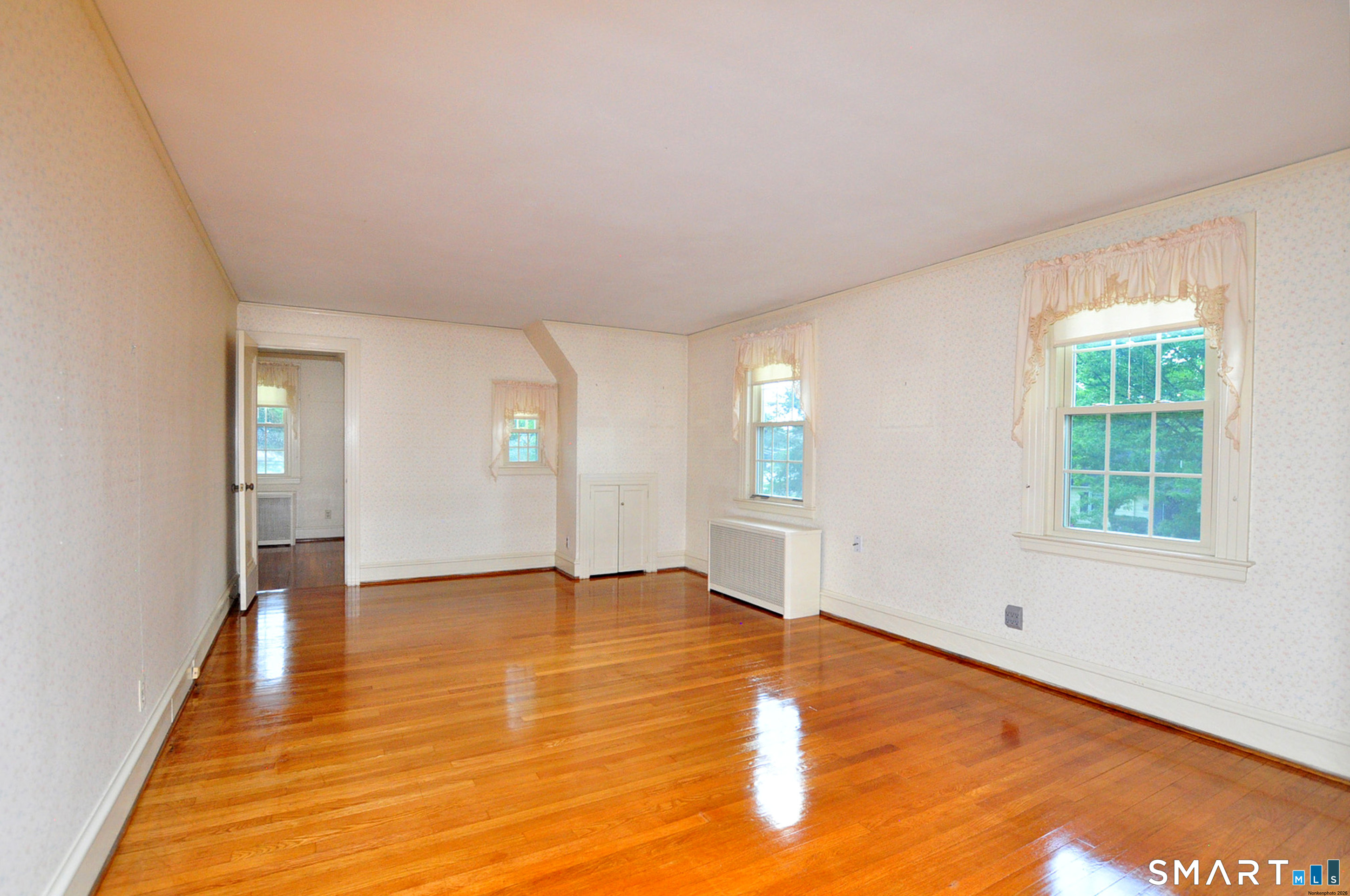 10 Harvey Road Windsor, CT 06095 - Photo 21 of 36 a view of an empty room with window and wooden floor