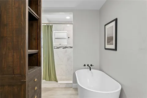 a bathroom with a white tub shower and vanity