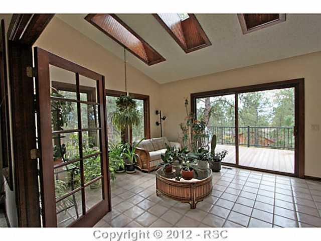 13010 Bridle Bit Road Colorado Springs, CO 80908 - Photo 12 of 25 Beautiful sunroom is situated off of the family room and features skylights, tile flooring and walks out to one of two composite decks.