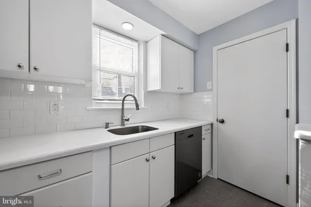 a kitchen with a sink and cabinets