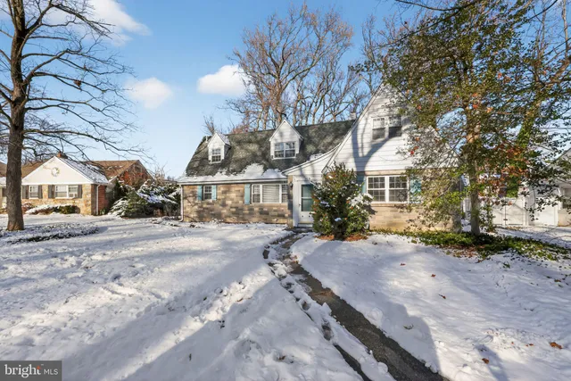 a view of a house with a yard covered with snow in the background