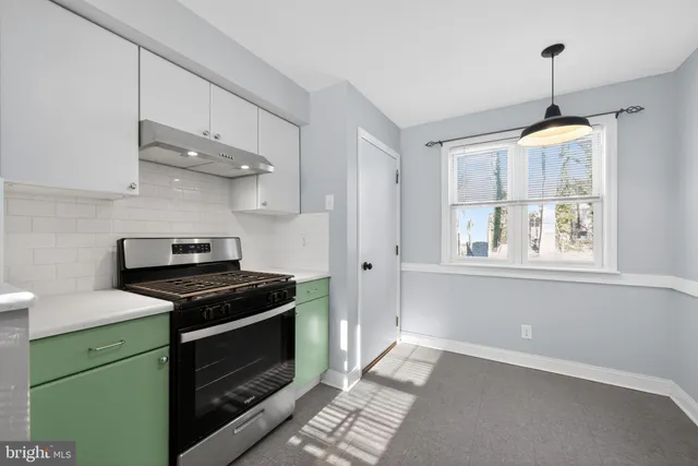 a kitchen with stainless steel appliances granite countertop a stove and a sink