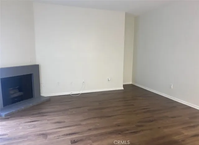 a view of an empty room and wooden floor