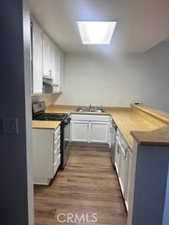 a kitchen with a sink stove and cabinets