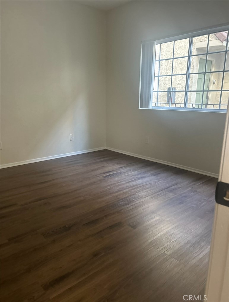 14448 Benefit Street, Unit 2 Sherman Oaks, CA 91423 - Photo 5 of 8 an empty room with wooden floor and windows