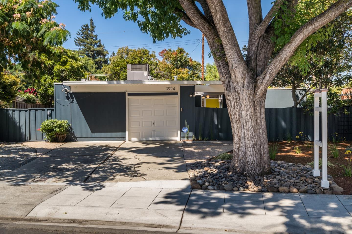 3924 Louis Road Palo Alto, CA 94303 - Photo 1 of 37 a view of a house with a tree in the background