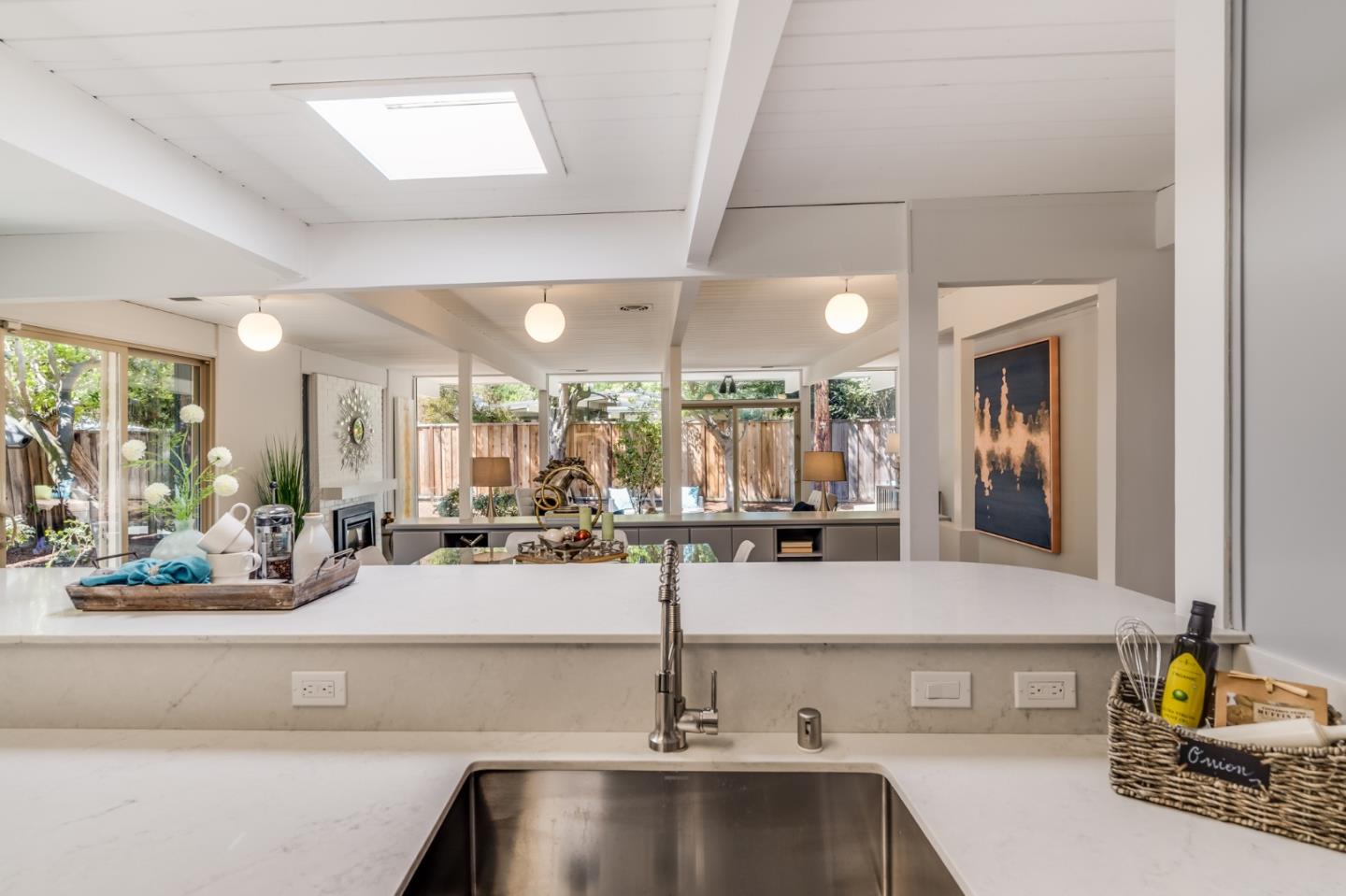 3924 Louis Road Palo Alto, CA 94303 - Photo 11 of 37 a view of a kitchen with kitchen island a counter top space a sink and cabinets