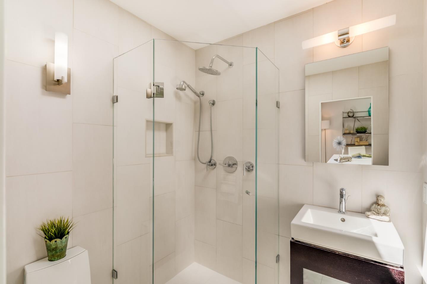 3924 Louis Road Palo Alto, CA 94303 - Photo 18 of 37 a bathroom with a sink a mirror and a shower