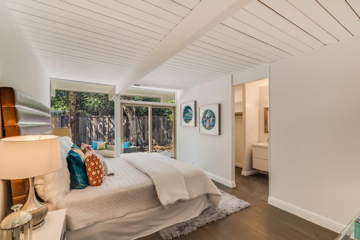 3924 Louis Road Palo Alto, CA 94303 - Photo 19 of 37 a bedroom with a bed and wooden floor