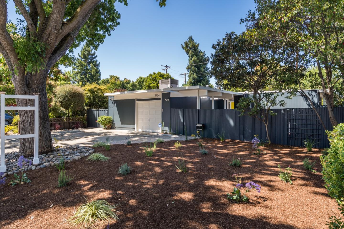 3924 Louis Road Palo Alto, CA 94303 - Photo 2 of 37 a backyard of a house with table and chairs