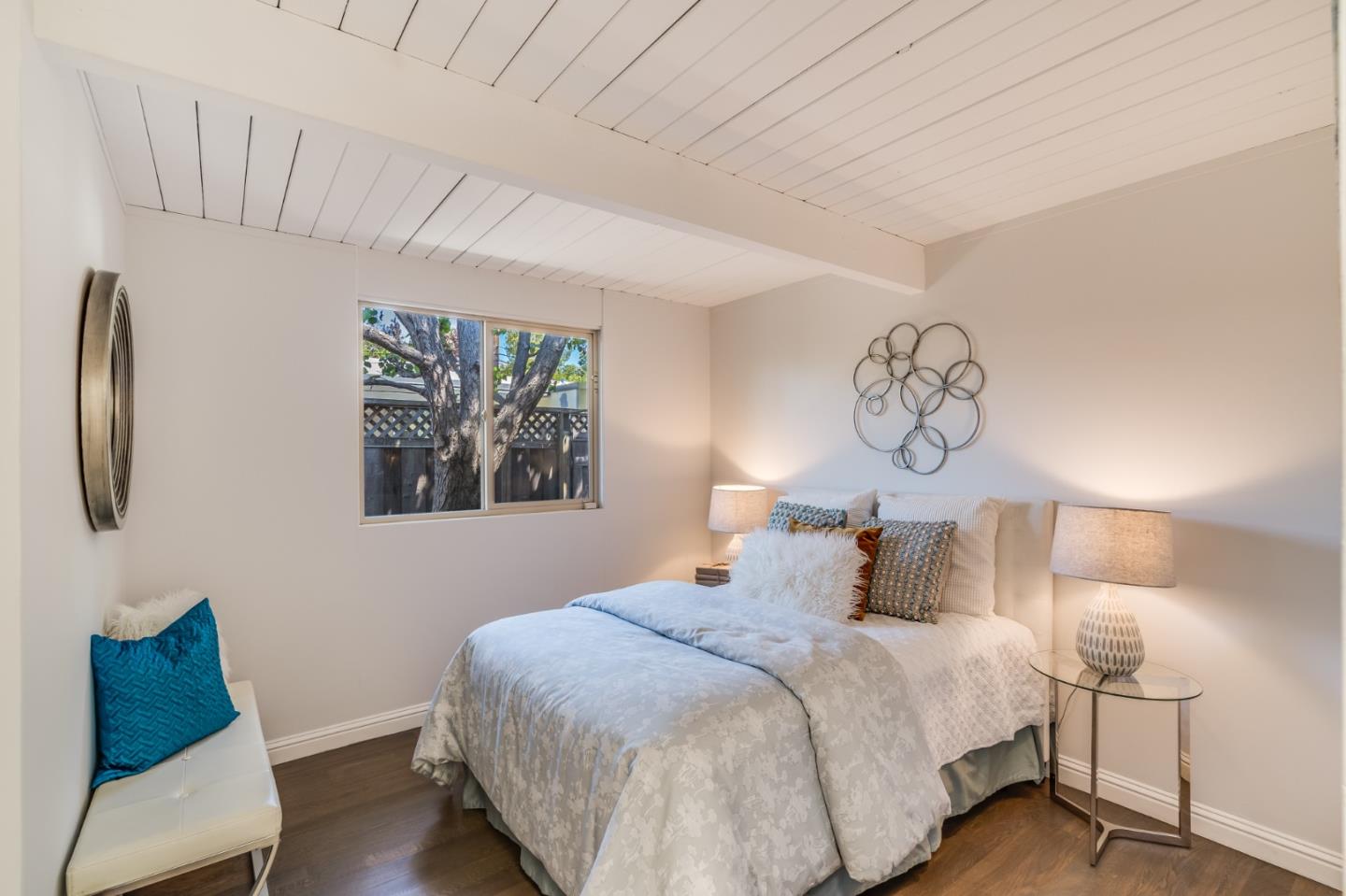 3924 Louis Road Palo Alto, CA 94303 - Photo 25 of 37 a bedroom with a bed and a chair