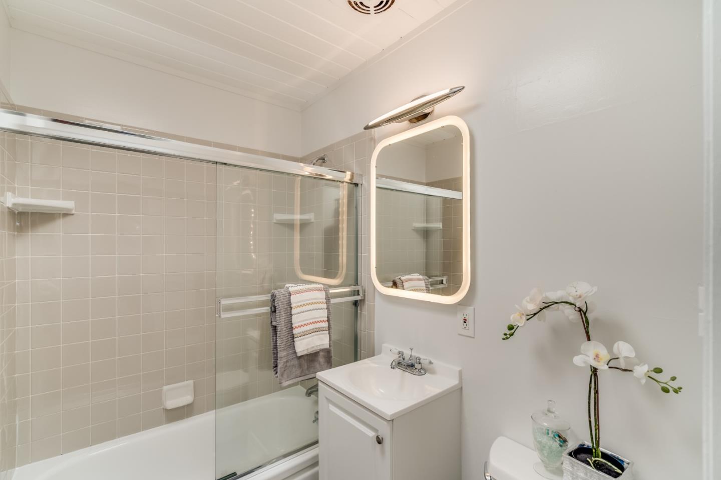 3924 Louis Road Palo Alto, CA 94303 - Photo 27 of 37 a bathroom with a bathtub shower sink vanity and toilet