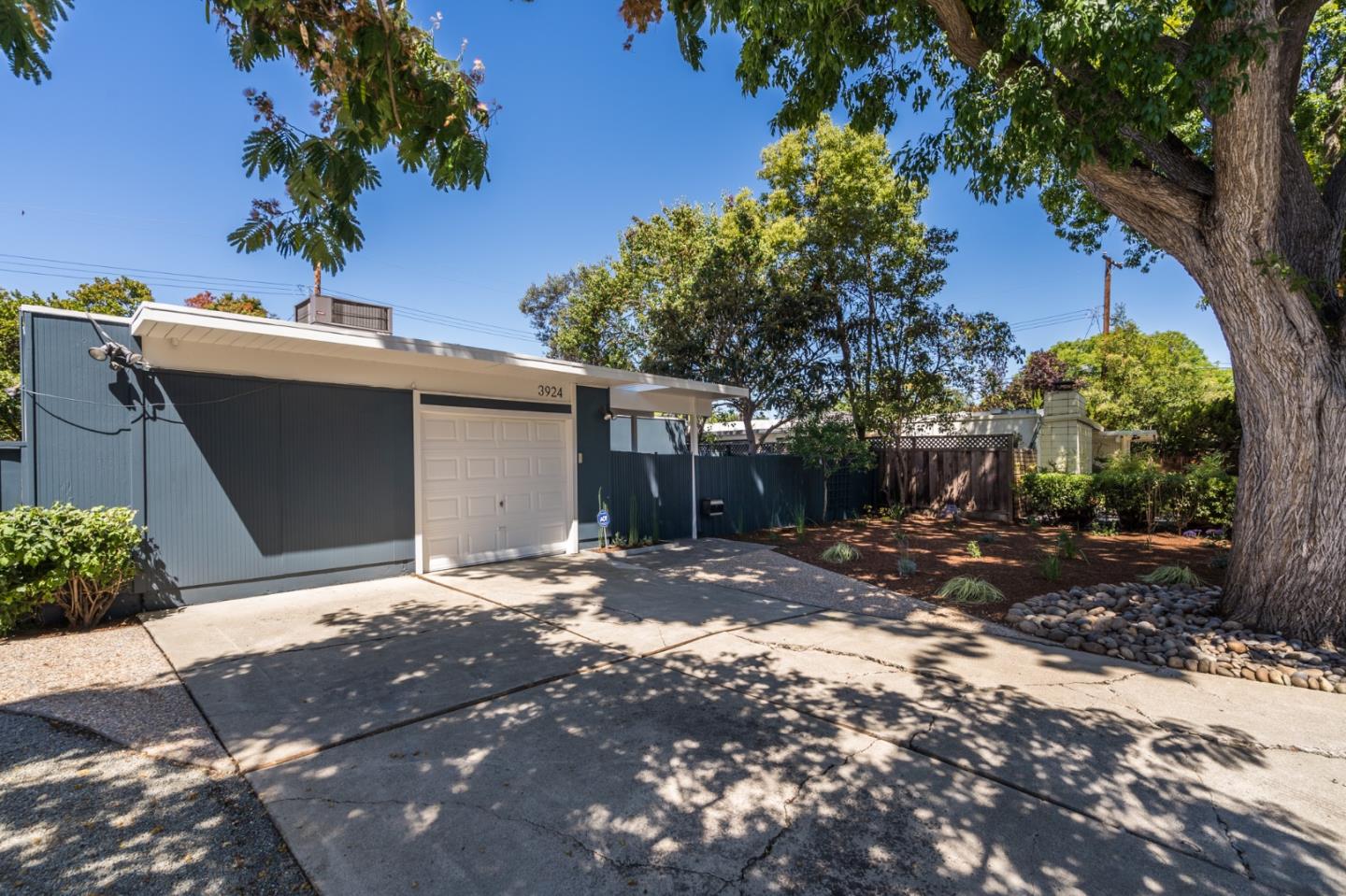 3924 Louis Road Palo Alto, CA 94303 - Photo 3 of 37 a backyard of a house with table and chairs