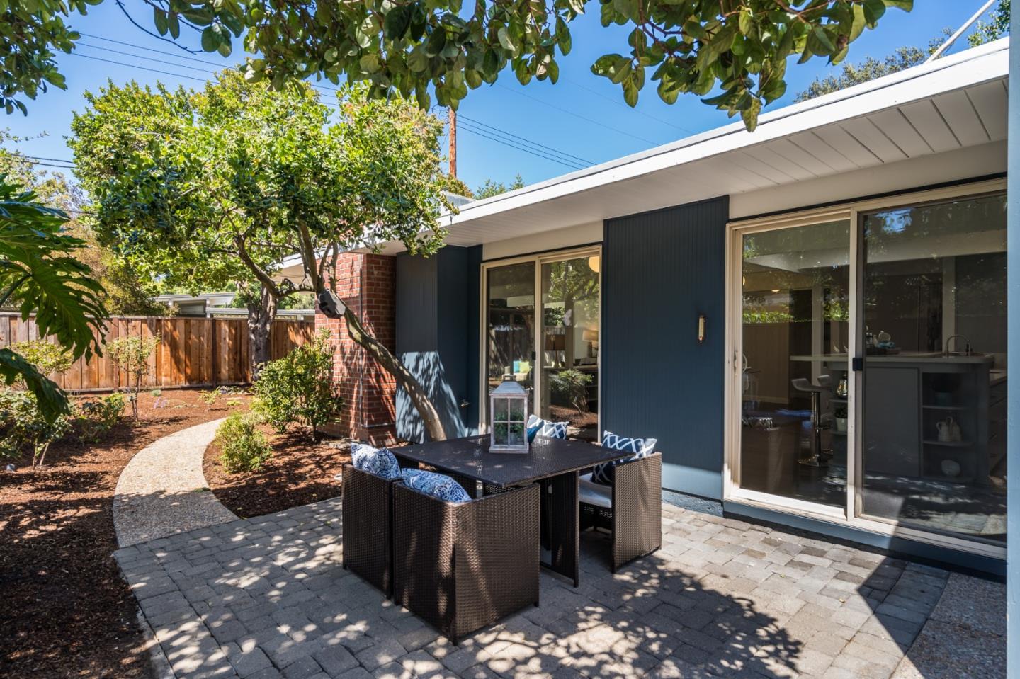 3924 Louis Road Palo Alto, CA 94303 - Photo 32 of 37 a view of a patio with table and chairs potted plants and floor to ceiling window