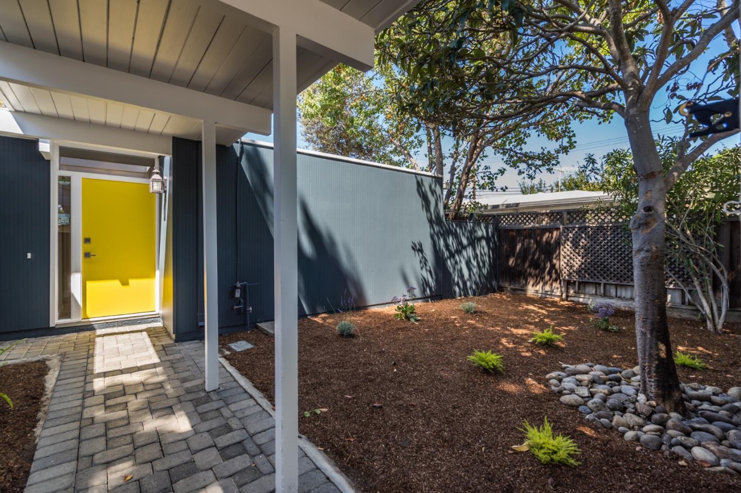 3924 Louis Road Palo Alto, CA 94303 - Photo 4 of 37 a view of a porch with a table and chairs next to a yard