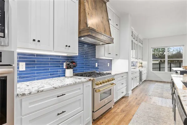 a kitchen with counter space appliances and a dining table