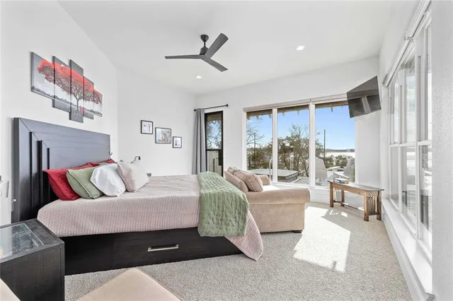a bathroom with double vanity sinks a large mirror and a bathtub