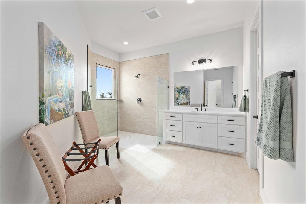 584 Oak Point Drive May, TX 76857 - Photo 27 of 40 a spacious bathroom with a double vanity sink and a mirror