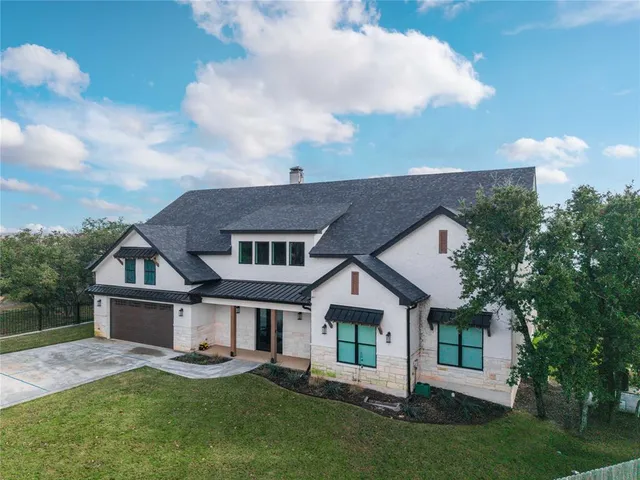 a view of a house with swimming pool and sitting area